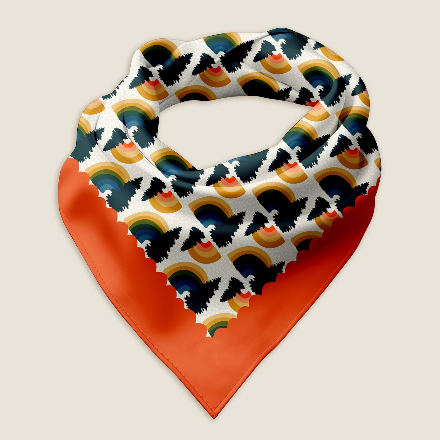 This is an image of the Rainbow Pine bandana scarf styled into a wrap showing the hand-drawn rainbows with pine tree on a white background with a scalloped red border. The words "Peace & Love" are tucked into one corner of the red border. Behind the scarf is a graphic of pine trees. The WanderWrap logo is at the top and the Posh Pad Designs logo is in the lower right corner. The Rainbow bandana is laying on an ivory background.