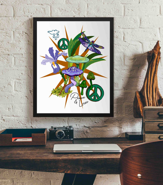 This photo shows the framed Peace & Love Wild Iris and Mushroom art print hanging on a white brick wall. Below it, there is a wood. The desk has a camera, laptop, and wood sculpture on it.