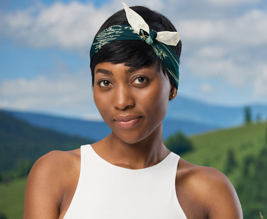 This is an image of a woman wearing the bandana as a headband. There is a mountain view behind her.