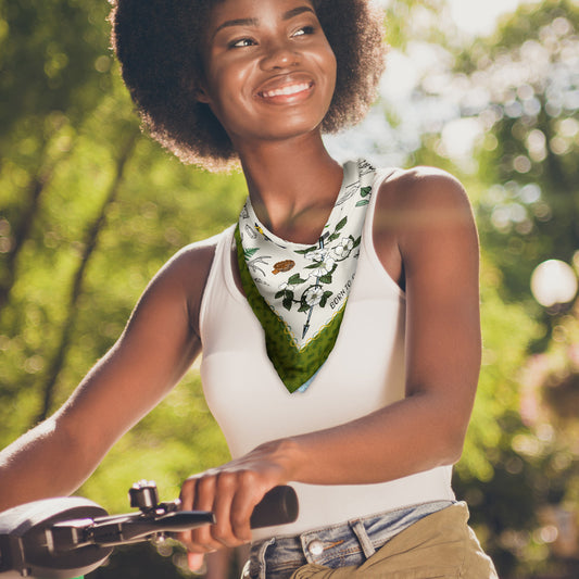 Woman on bicycle wearing the Born to Roam bandana around her neck.