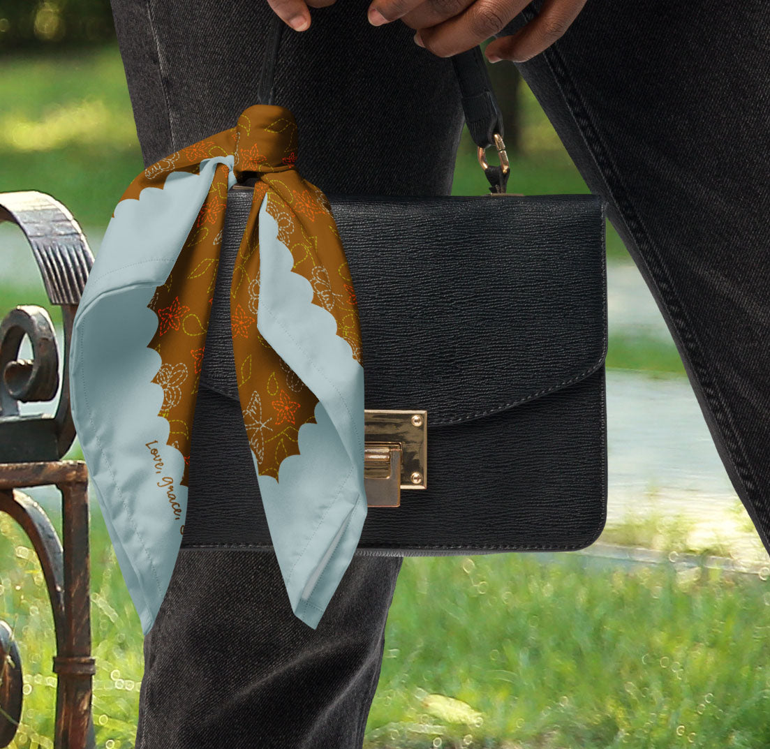This is a photo of the Cowgirl Stitches bandana scarf styled as a purse accessory.