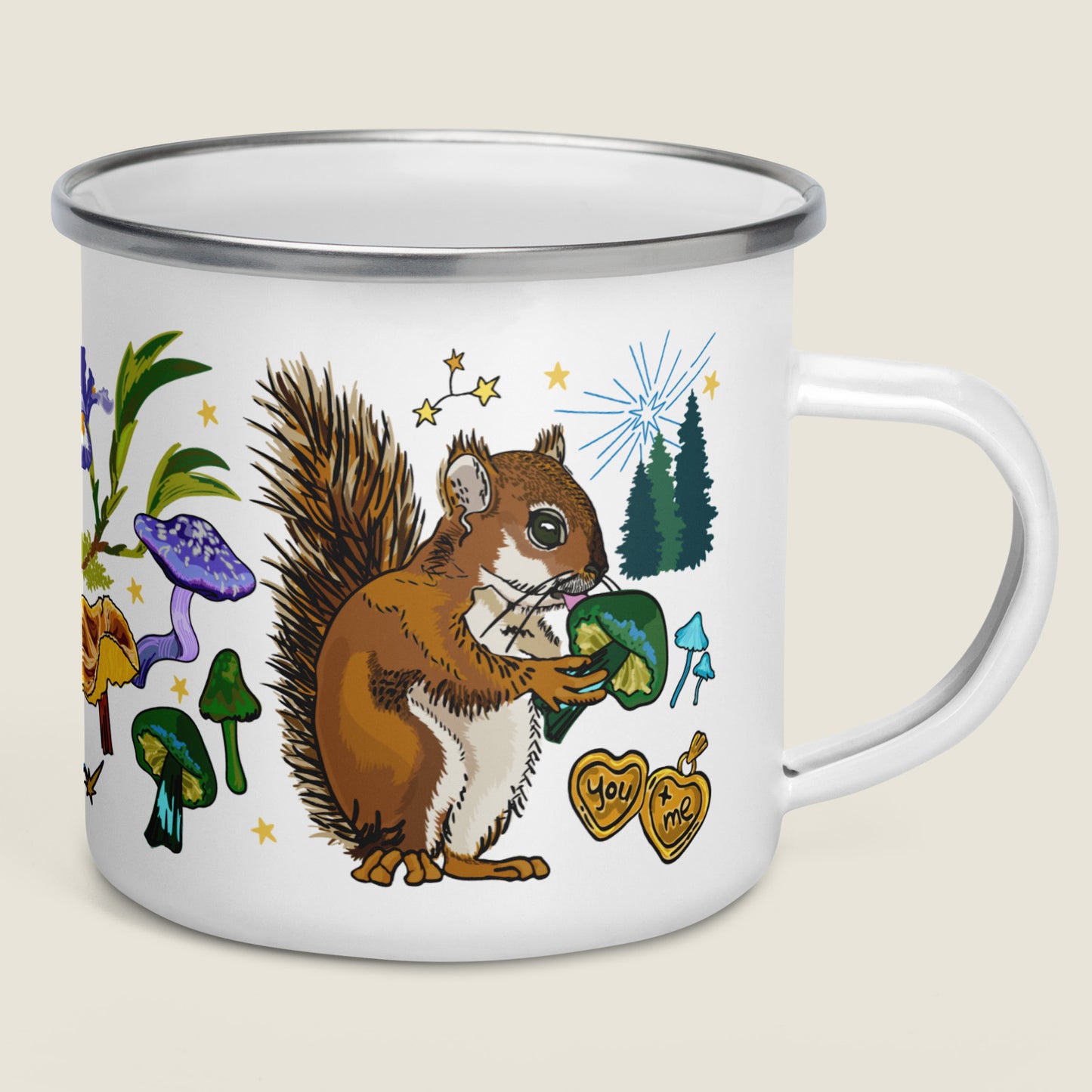 The Cygnus Constellation camp mug on an ivory background. The artwork shows illustrations inspired by the cosmic good fortune of the forest. There's a gold locket with the words "you + me", magical mushrooms, pine trees, stars, and a cheeky squirrel.