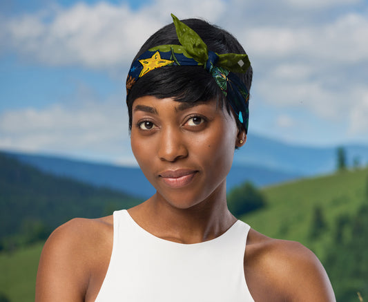 This is an image of a woman wearing the bandana as a headband. There is a mountain view behind her.