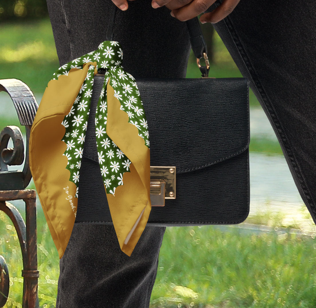This is a photo of the Daisy Flower bandana scarf styled as a purse accessory.
