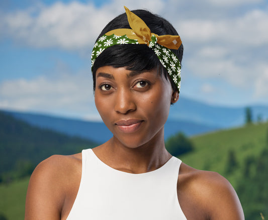 This is an image of a woman wearing the bandana as a headband. There is a mountain view behind her.