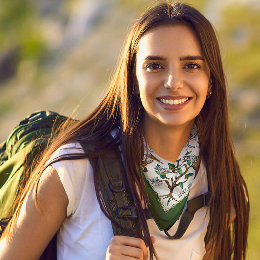 Woman with a backpack wearing the Fierce, Feral, and Free Bandana around her neck.