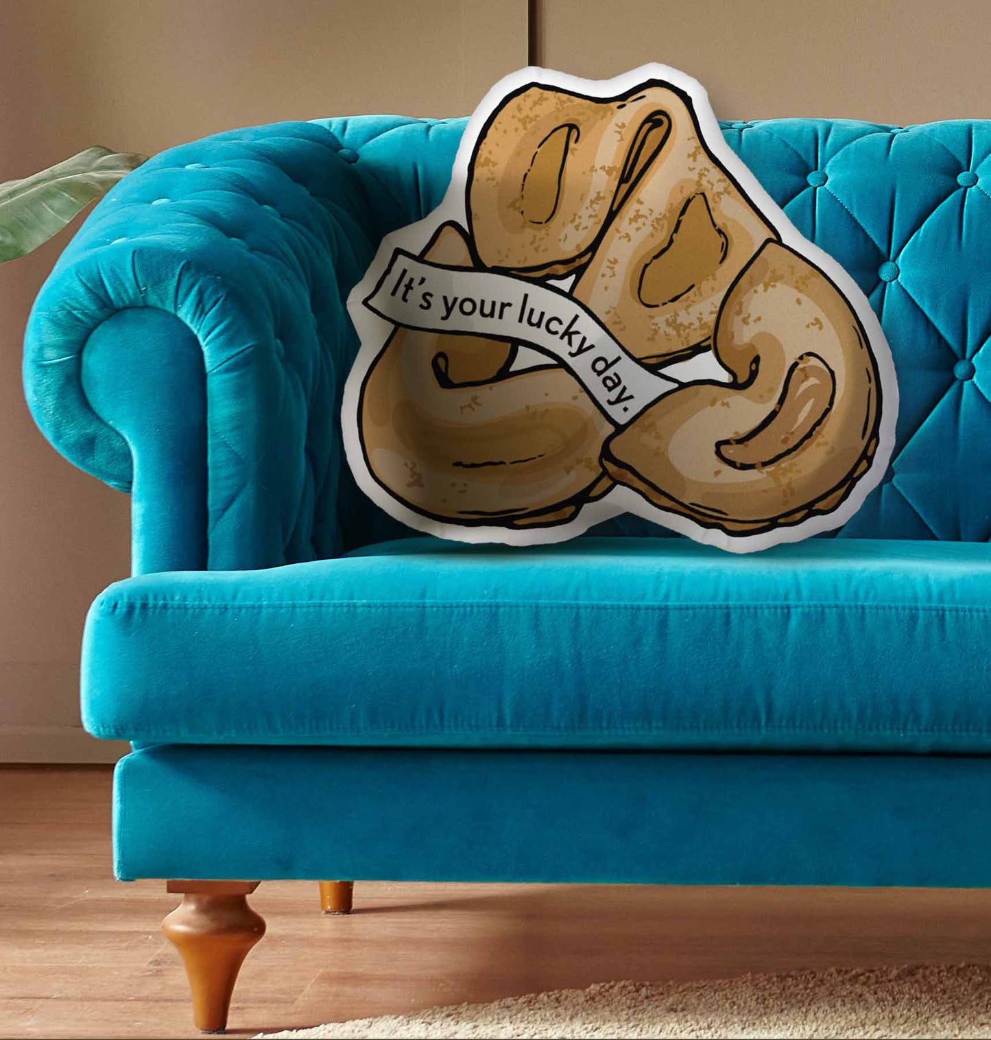 This photo shows the pillow on a bright blue couch.