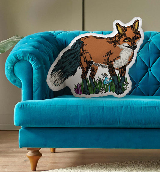 The Fox pillow on a blue couch.