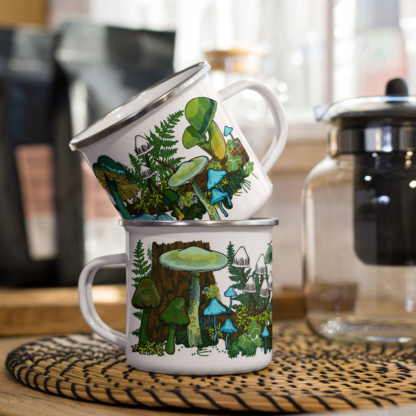 Green mushroom enamel coffee cups stacked on kitchen counter.