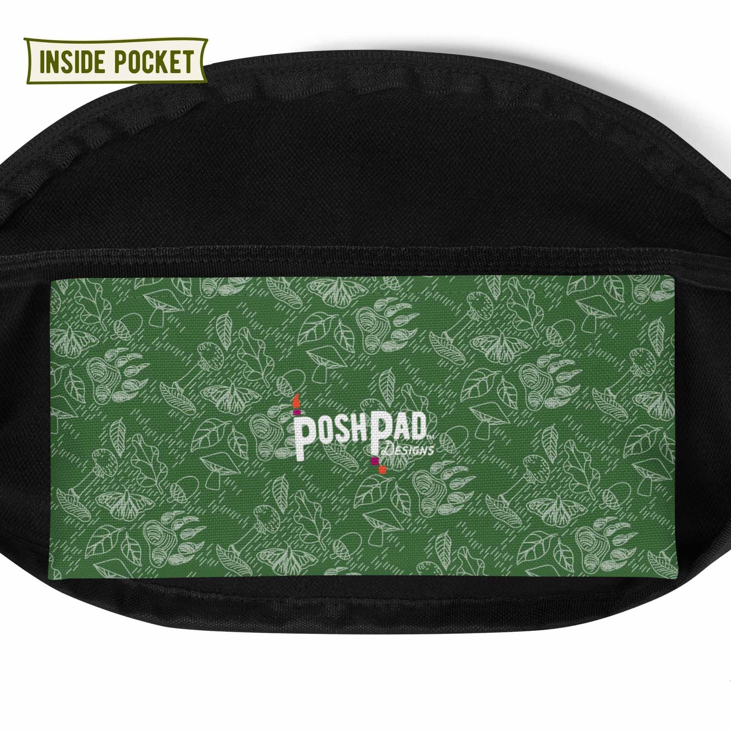View of the inside pocket. It has a white pattern of bear paws, mushrooms, butterflies, and leaves on a green background. The Posh Pad logo is in the middle.