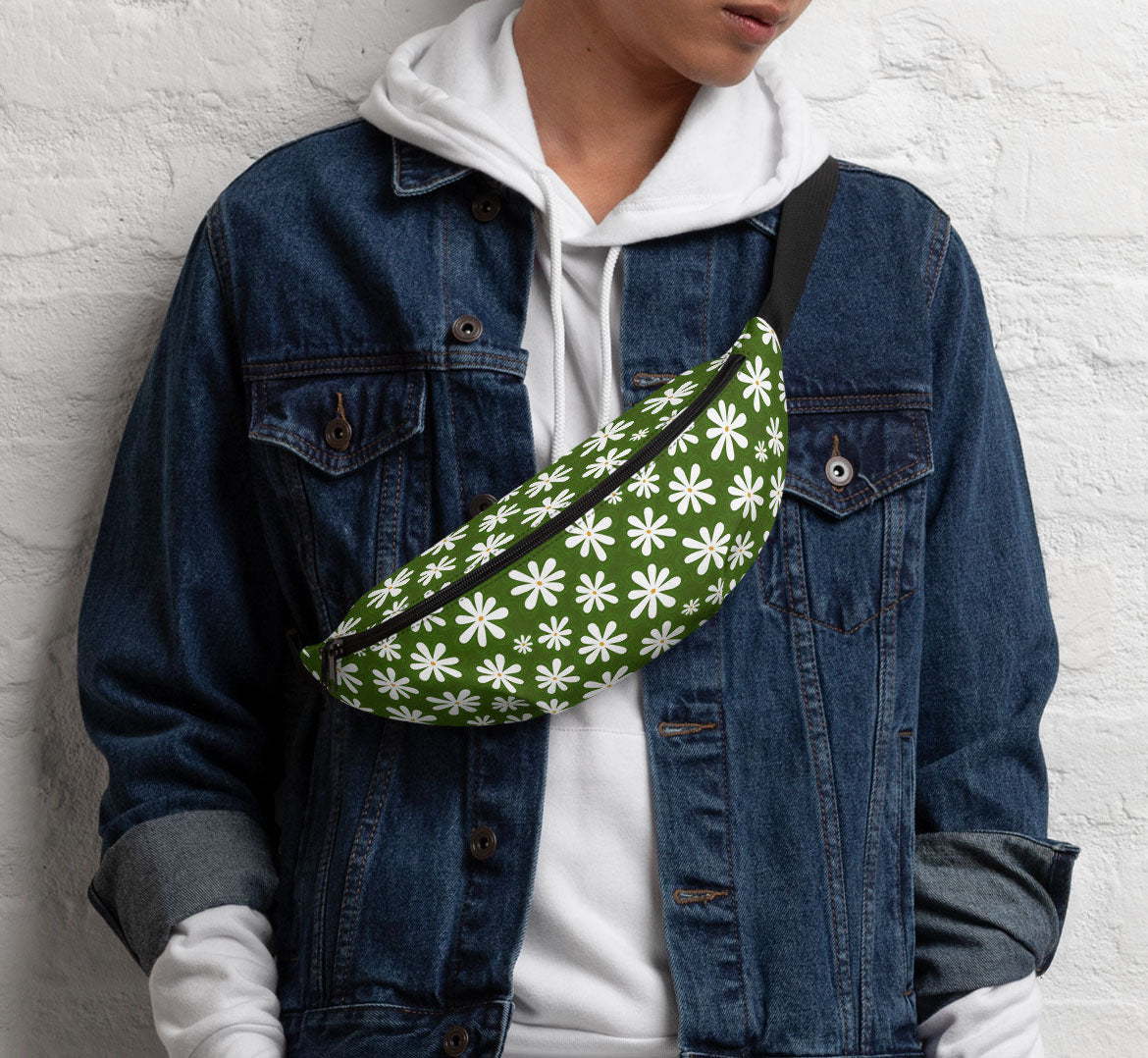 Pack worn in a sling bag style over a denim jacket and a white hoodie.