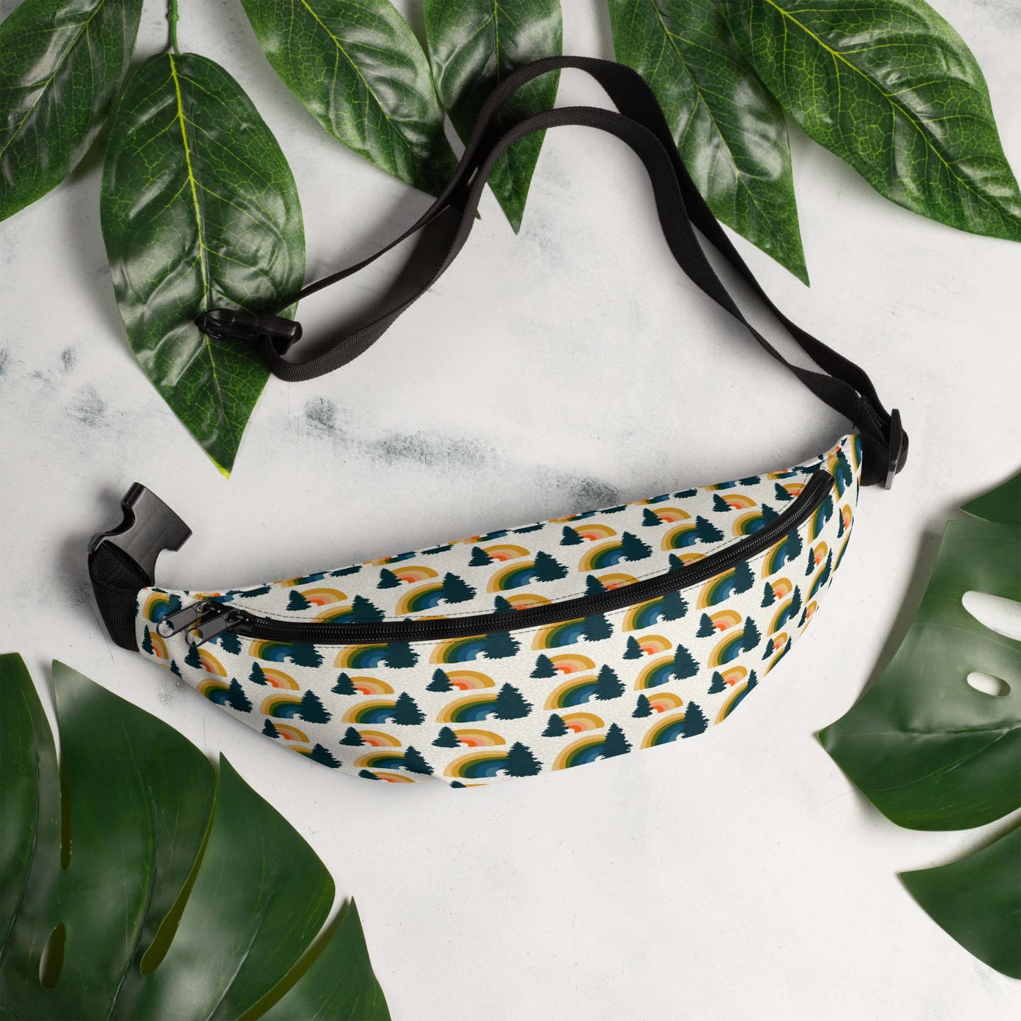 Hip pack laying on a marble table surrounded by leaves.