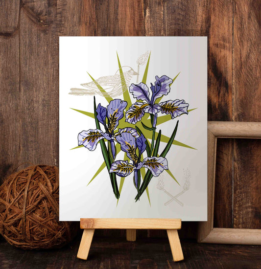 Lucky Star art poster on a wooden easel set against a wood-paneled wall. The art has a multi-pointed green star in the background. On top of that, there are wild irises that embody wisdom, royalty, and respect. The bird with burning matches symbolizes the hardships we've overcome.