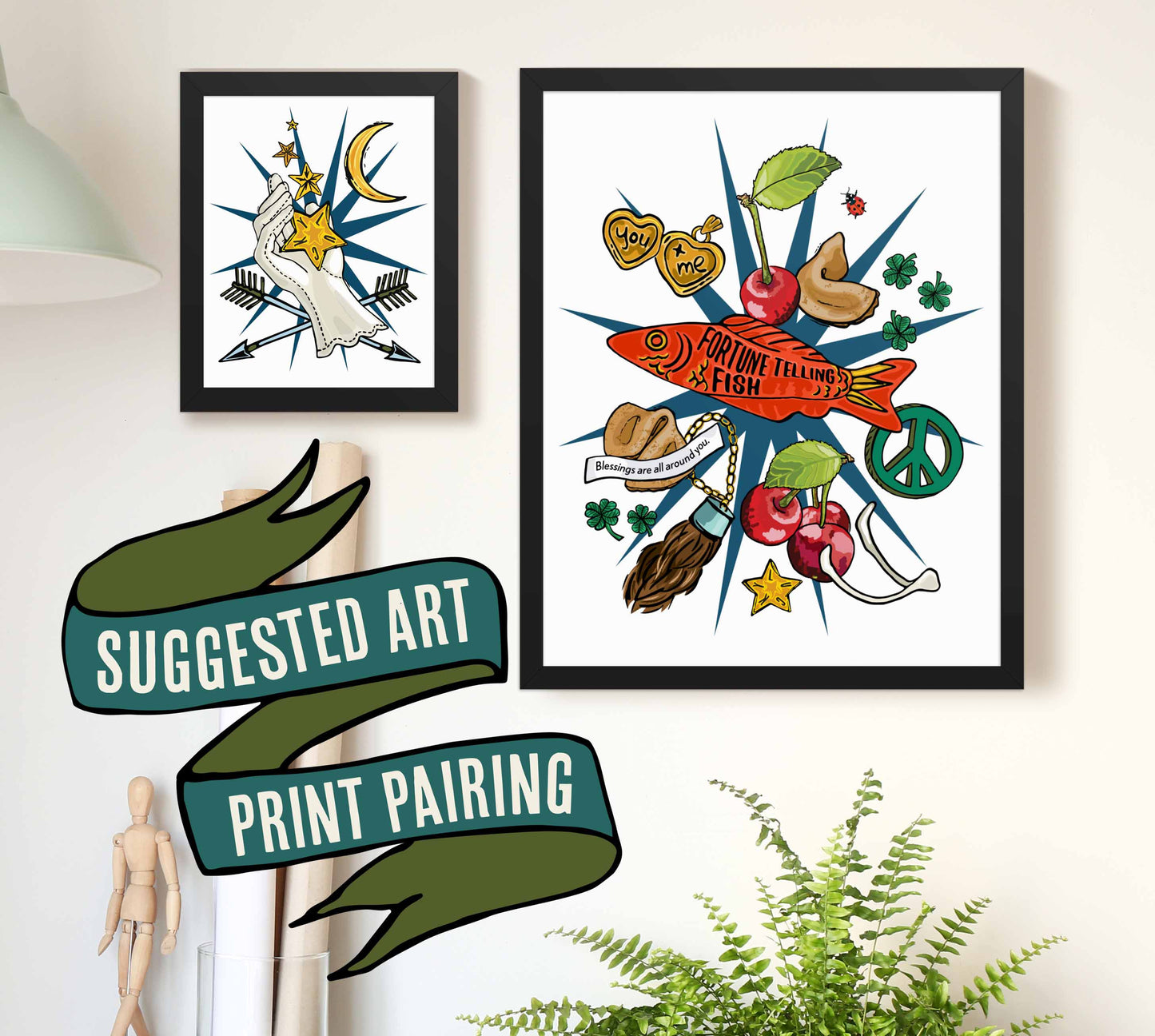 This is a photograph of two framed art prints from the Posh Pad Appalachian Rococo collection with a ribbon stating that this is a suggested art print pairing. The two prints in the photo are the Lucky Star & Crescent Moon paired with the Good Luck Charms Fortune art print.