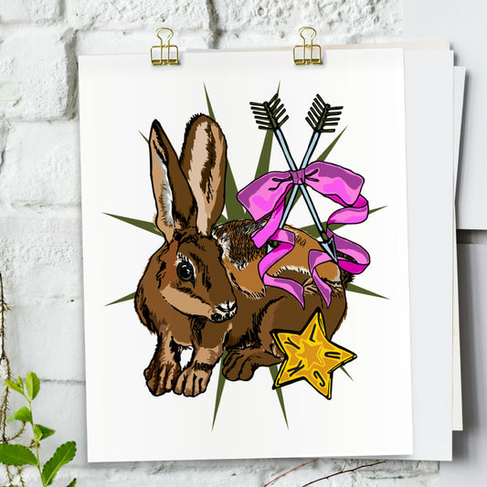 Lucky Rabbit art print hanging from a white bring wall with gold clips.