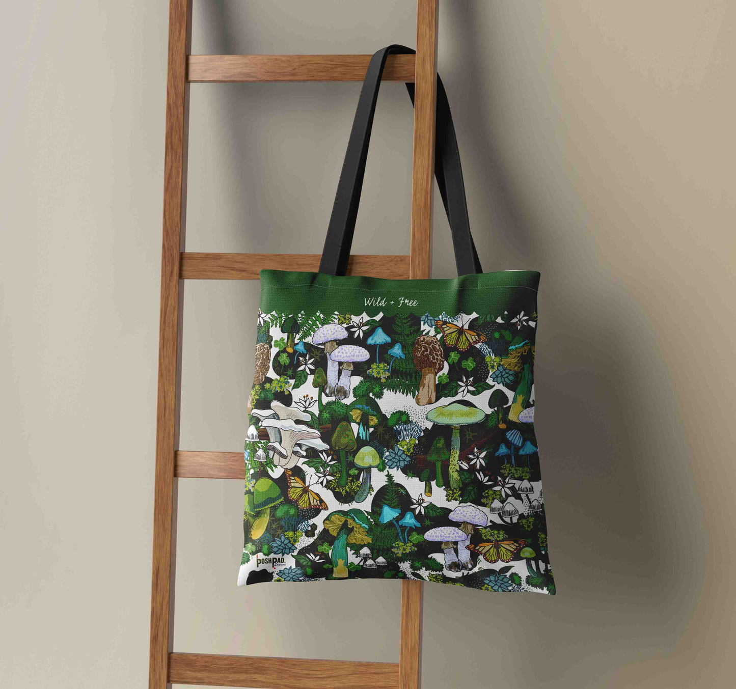This image shows the Green Mushroom weekender tote hanging on a wooden ladder.