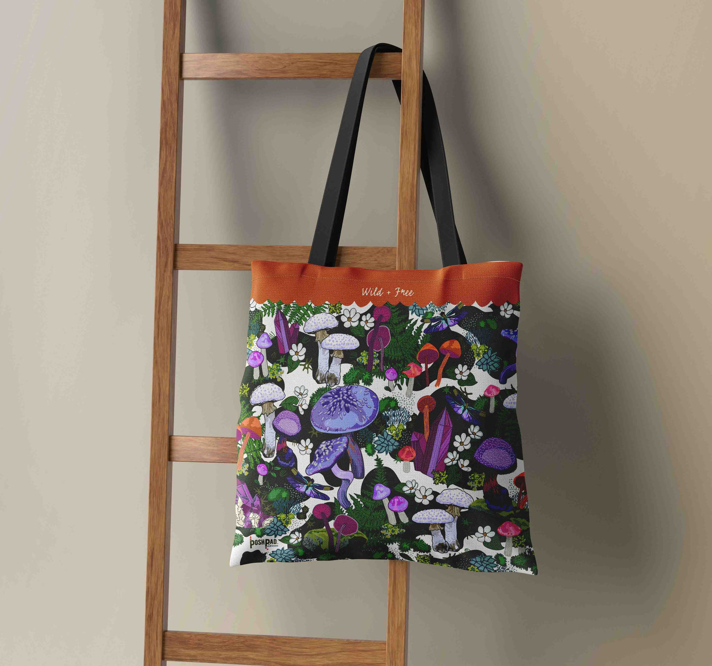 This image shows the Purple Mushroom weekender tote hanging on a wooden ladder.