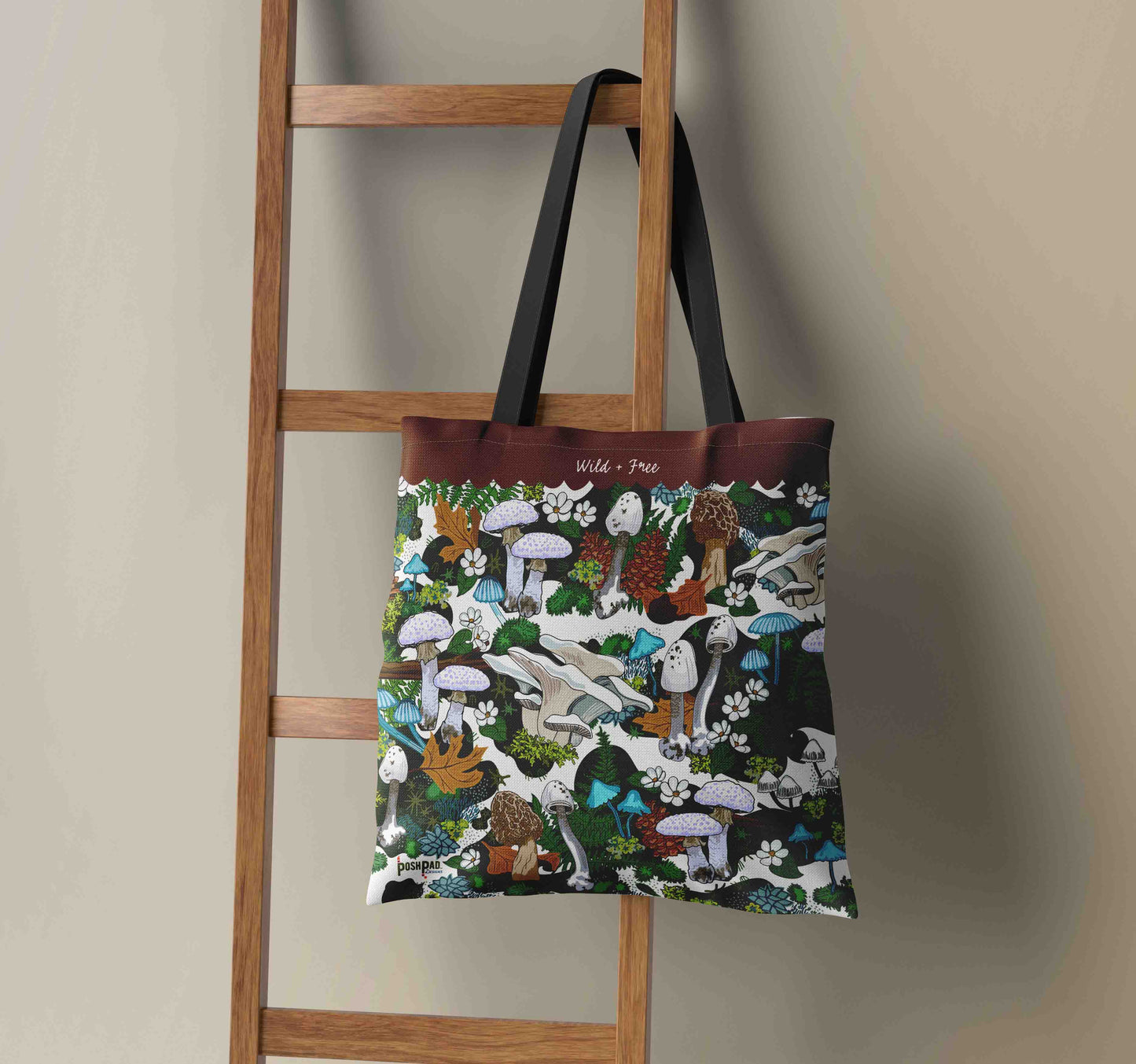 This image shows the Green Mushroom weekender tote hanging on a wooden ladder.