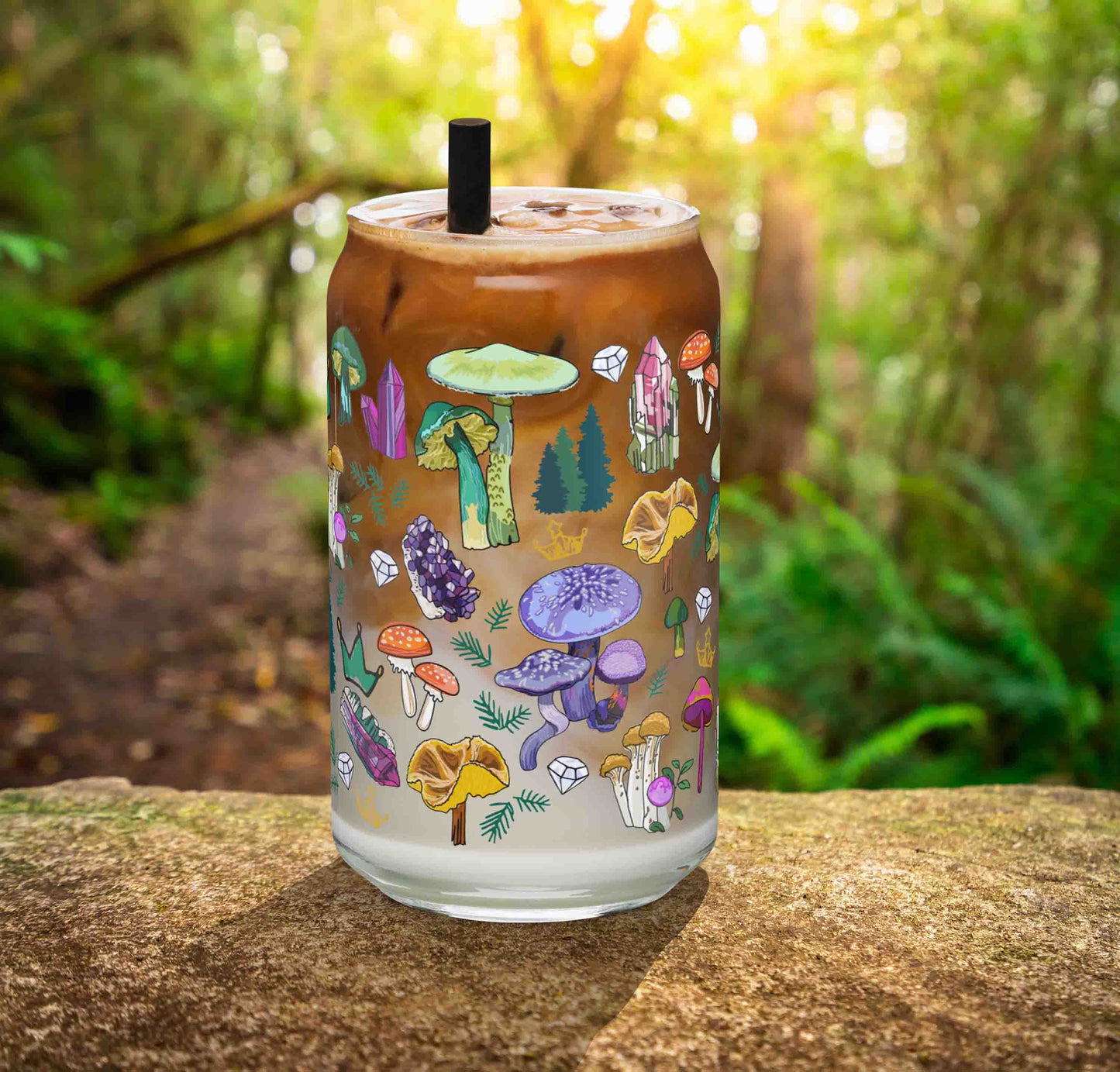 This is a photo of the glass containing an iced latte. It's sitting on a rock in the woods.