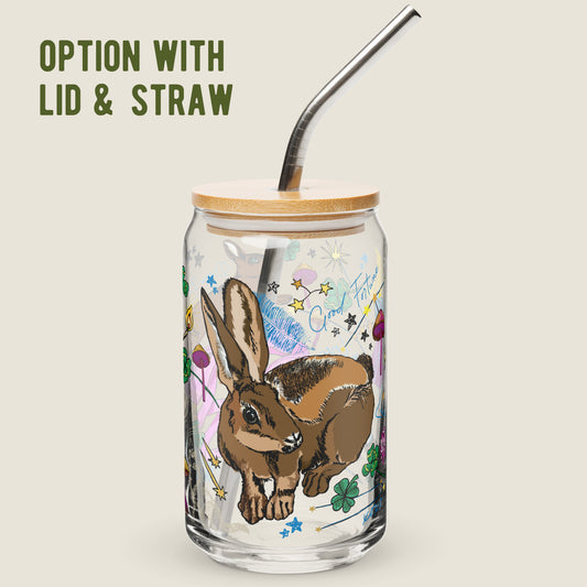 Orion Constellation glass tumbler with the lid and straw option on an ivory background. The artwork on the glass is an illustration of the Orion Constellation, which holds the "Three Lucky Stars", long considered to symbolize prosperity, longevity, and happiness. The illustration includes lucky rabbits, four-leaf clovers, mushrooms, stars, a crescent moon, burning matches, bows and arrows for loyalty, and other symbols of good fortune. The color palette is primarily golden yellows, pinks, greens, and blues.