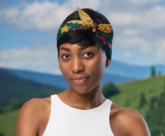 This is an image of a woman wearing the bandana as a headband. There is a mountain view behind her.