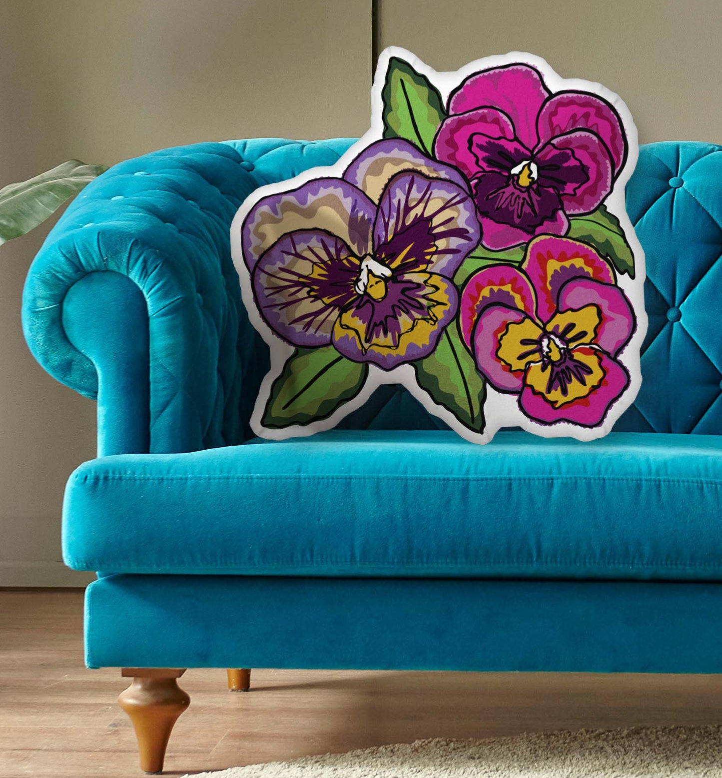 This is a photo of the shaped pillow on a blue couch.