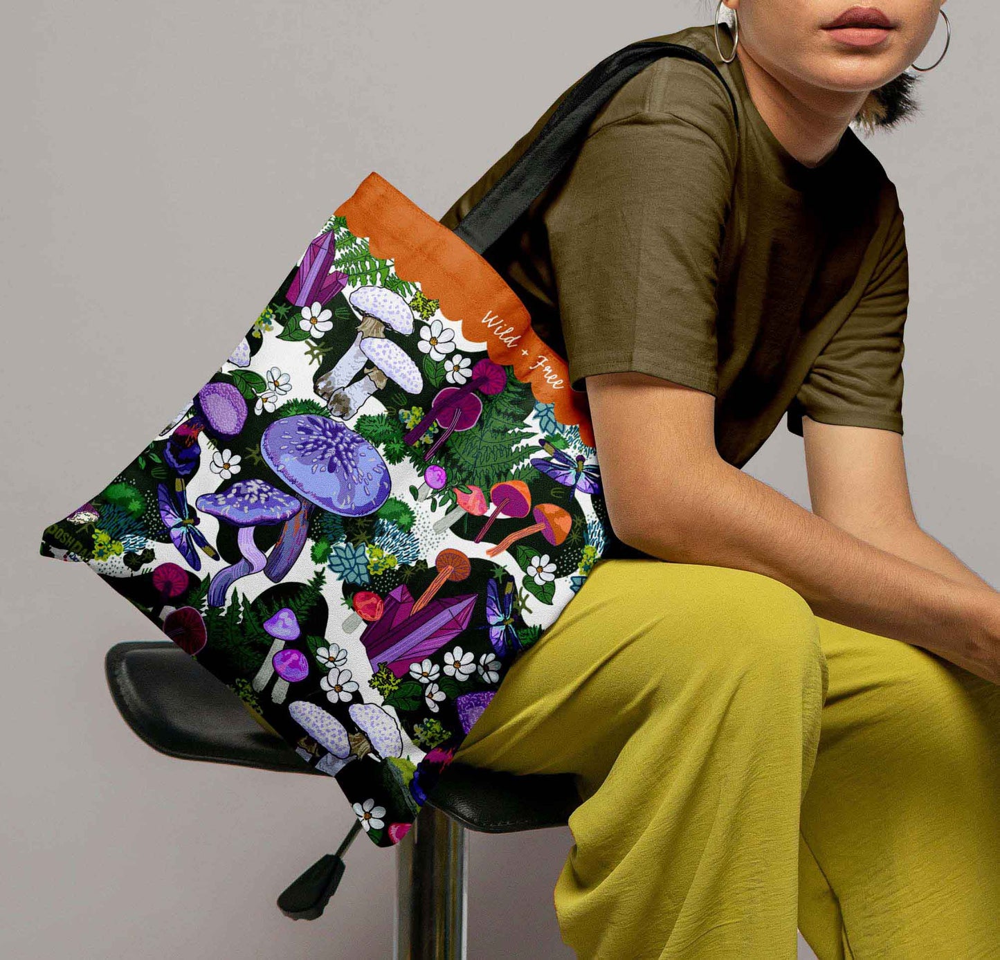 This is a photo of a woman with the tote bag on her shoulder to show the size of the bag.