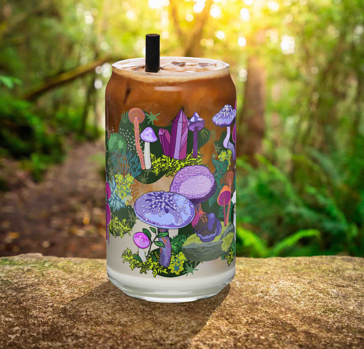 This is a photo of the glass containing an iced latte. It's sitting on a rock in the woods.