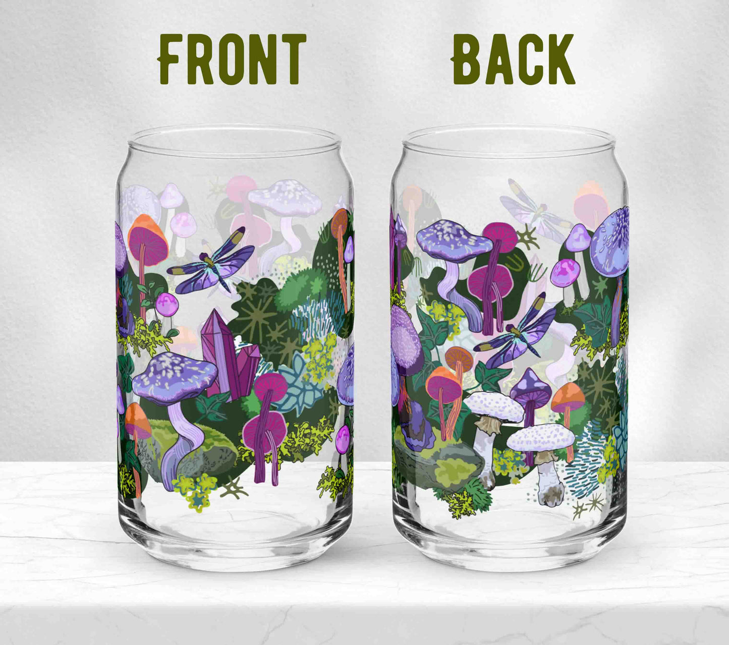 Two glasses sitting on marble. Each one is turned in a different direction to show the front and the back of the design. The artwork on the glass is a collection of purple and orange mushrooms, dragonflies, and various mosses nestled among wild ivy. The primary color palette is purples, vibrant oranges, and forest greens.