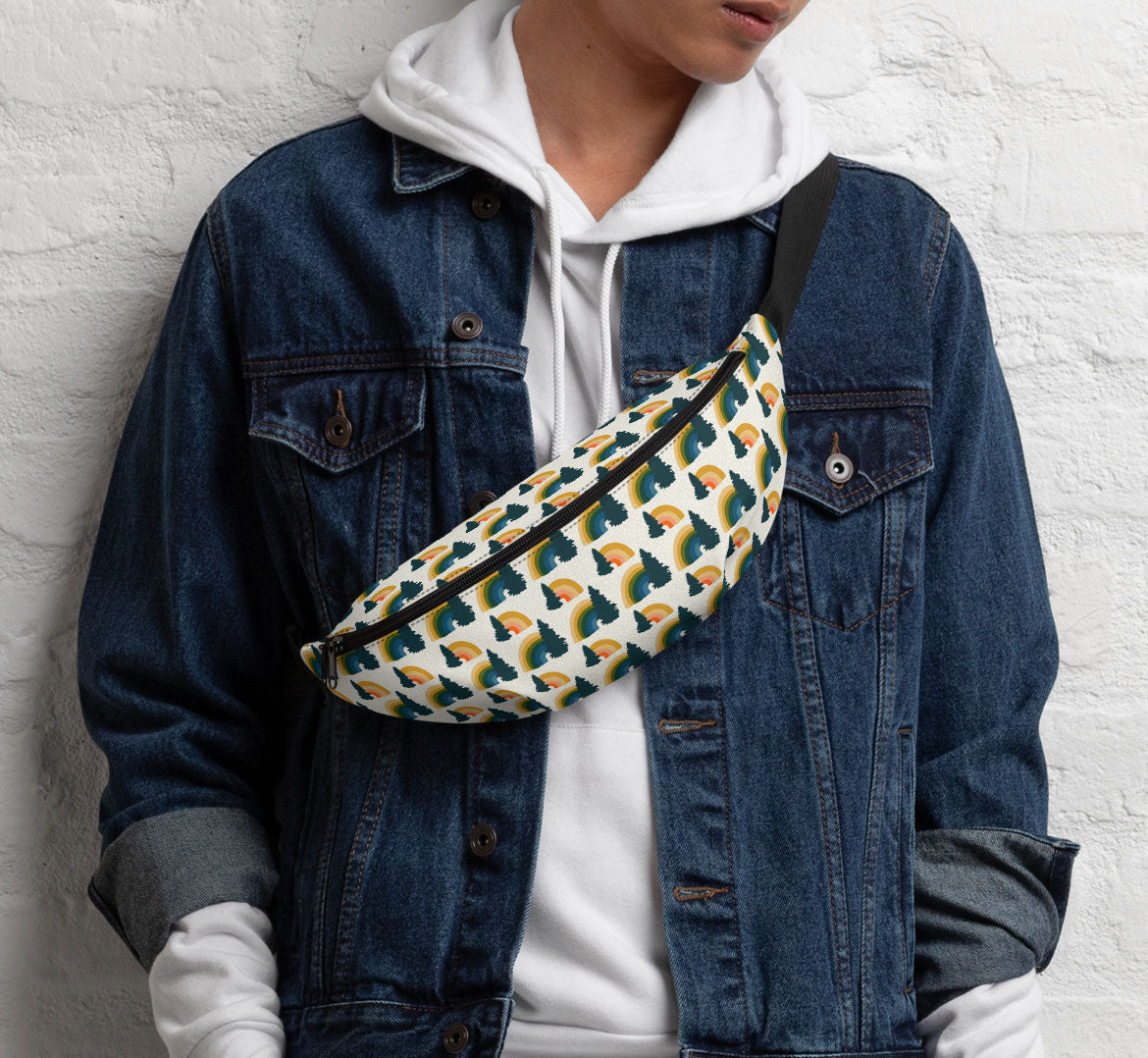 Pack worn in a sling bag style over a denim jacket and a white hoodie.