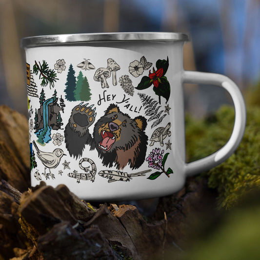 Smoky Mountains mug sitting on a tree stump in the woods.