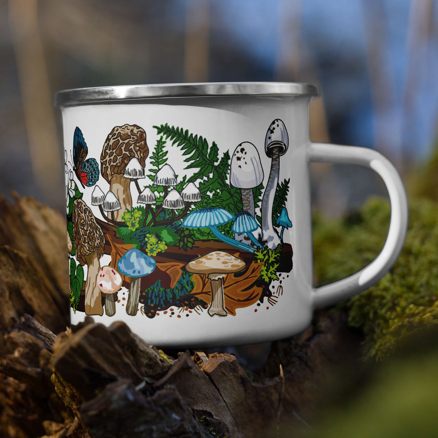 White mushroom enamel coffee mug on a tree stump with moss.
