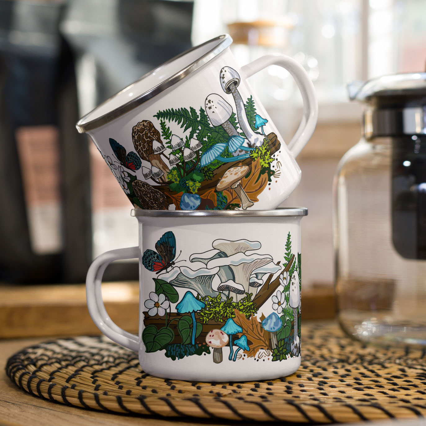 Two white mushroom mugs stacked on a kitchen counter.
