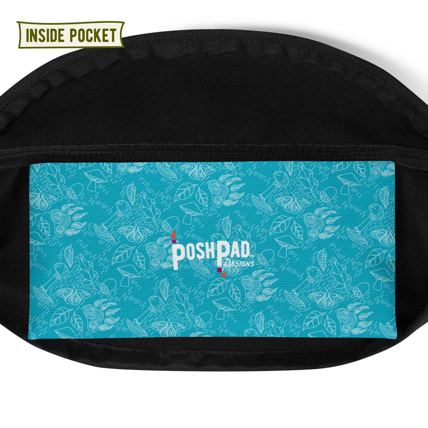 View of the inside pocket. It has a white pattern of bear paws, mushrooms, butterflies, and leaves on a blue background. The Posh Pad logo is in the middle.