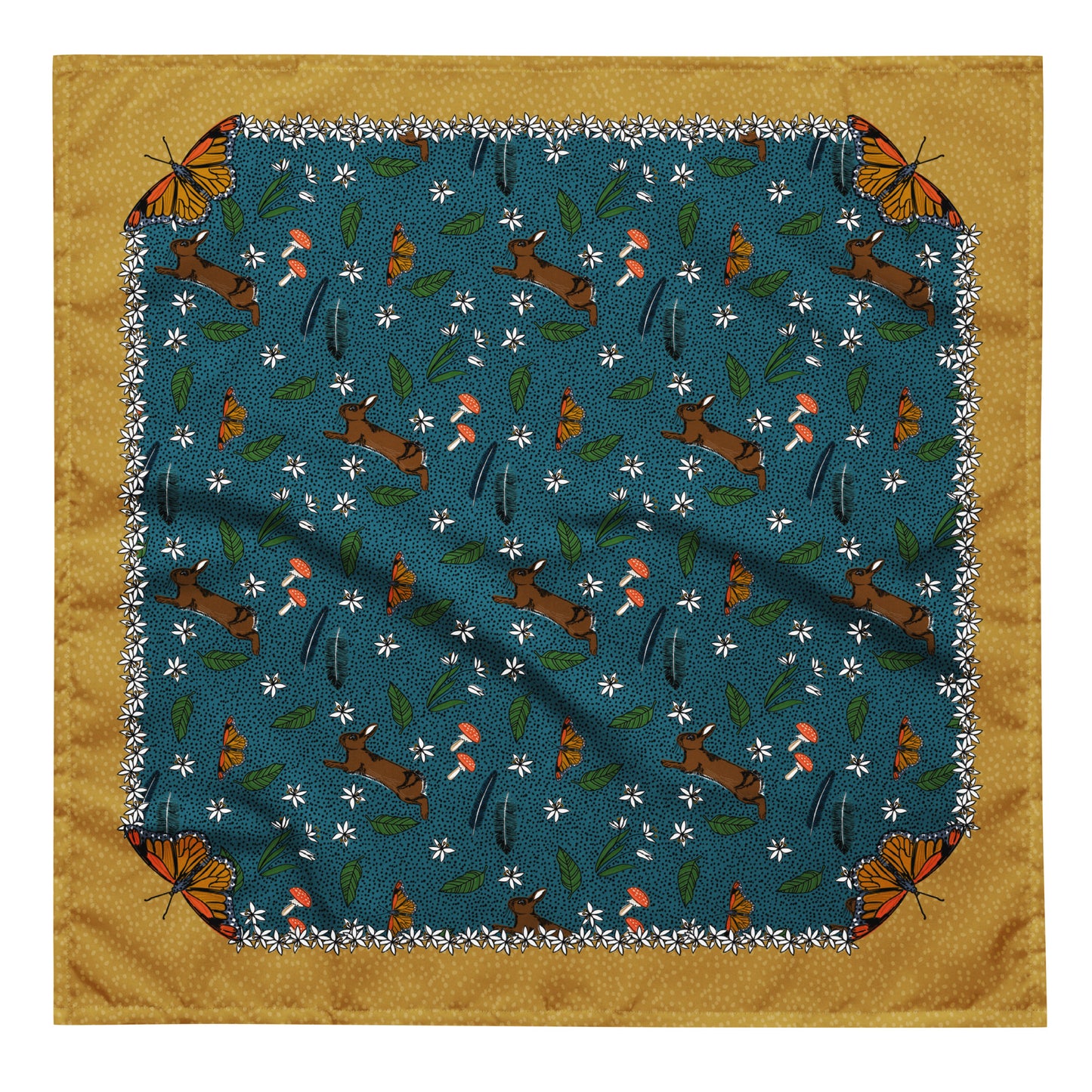 This is a flat image of the rabbit meadow bandana scarf. The pattern has rabbits, mushrooms, butterflies, feathers, and flowers on a dotted blue background. The border is mustard yellow with a light yellow dot pattern. Each corner has a butterfly.