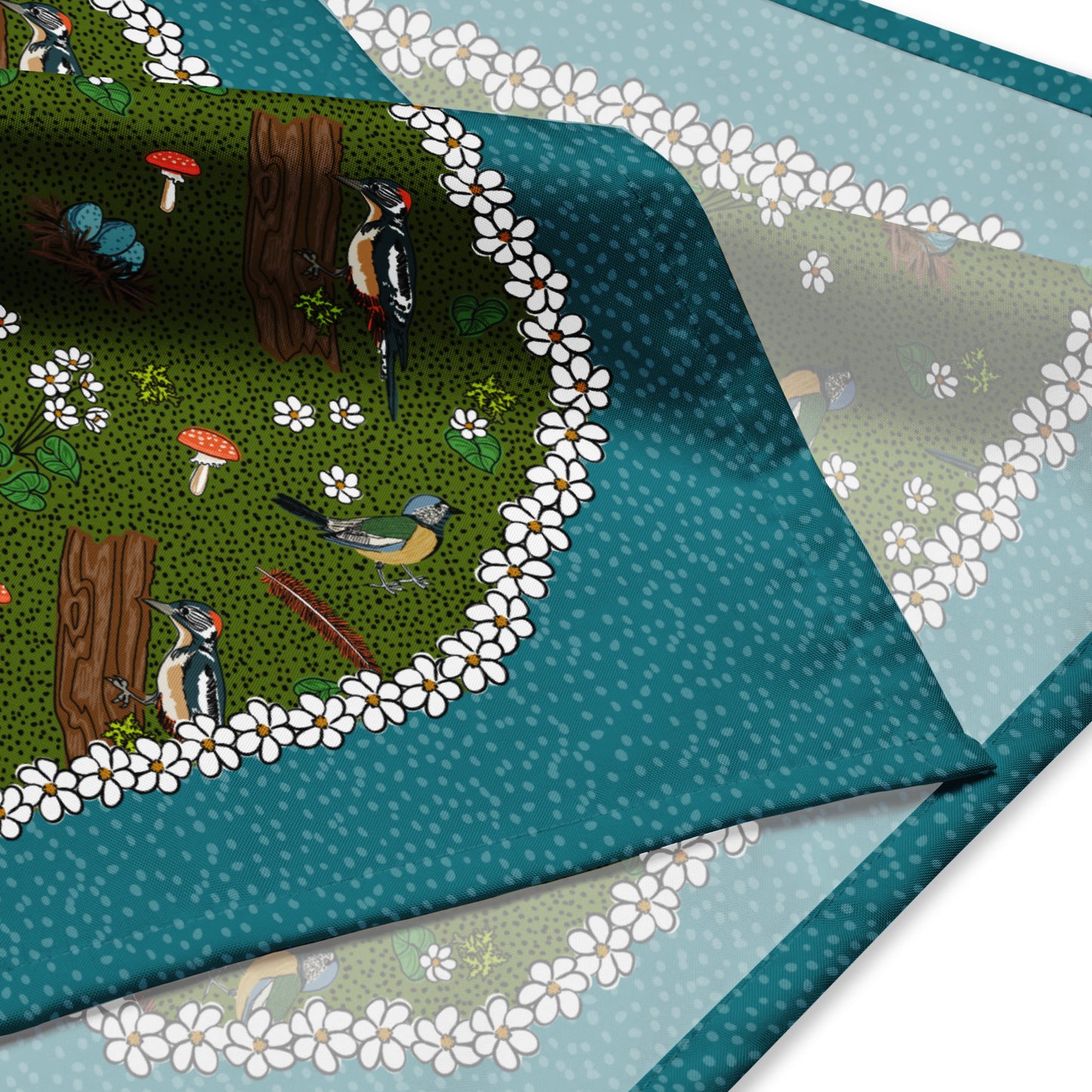 Detail shot of the bird bandana. Shows the illustrations of the birds, mushrooms, flowers, feathers, and bird nests.