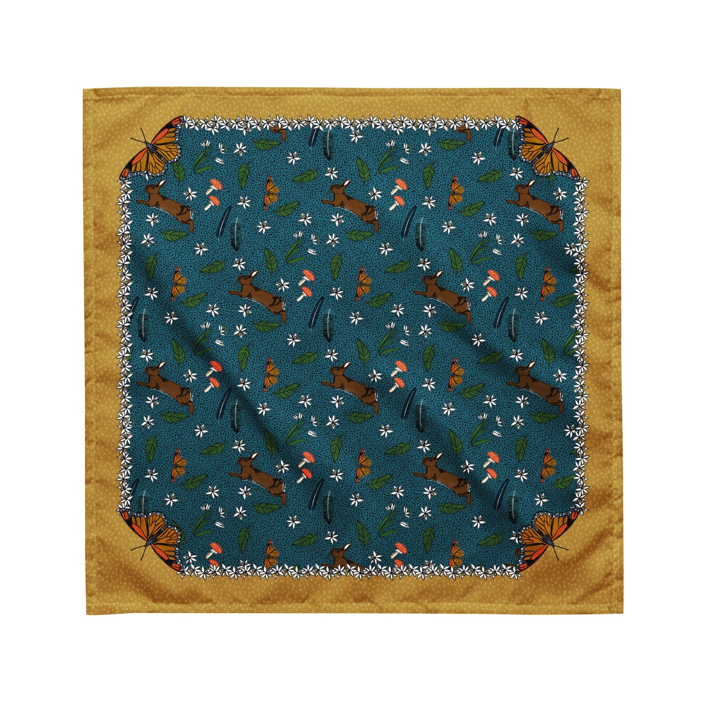 This is a flat image of the rabbit meadow bandana scarf. The pattern has rabbits, mushrooms, butterflies, feathers, and flowers on a dotted blue background. The border is mustard yellow with a light yellow dot pattern. Each corner has a butterfly.