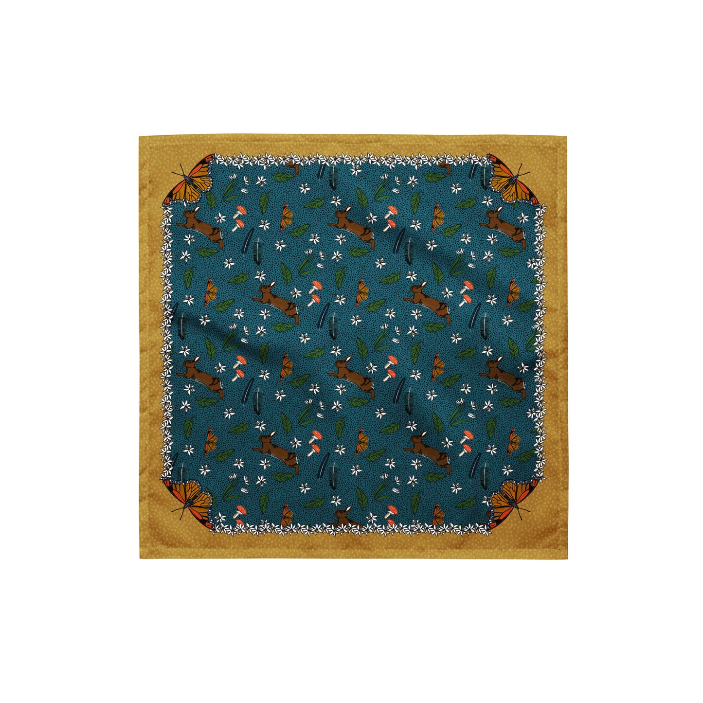 This is a flat image of the rabbit meadow bandana scarf. The pattern has rabbits, mushrooms, butterflies, feathers, and flowers on a dotted blue background. The border is mustard yellow with a light yellow dot pattern. Each corner has a butterfly.
