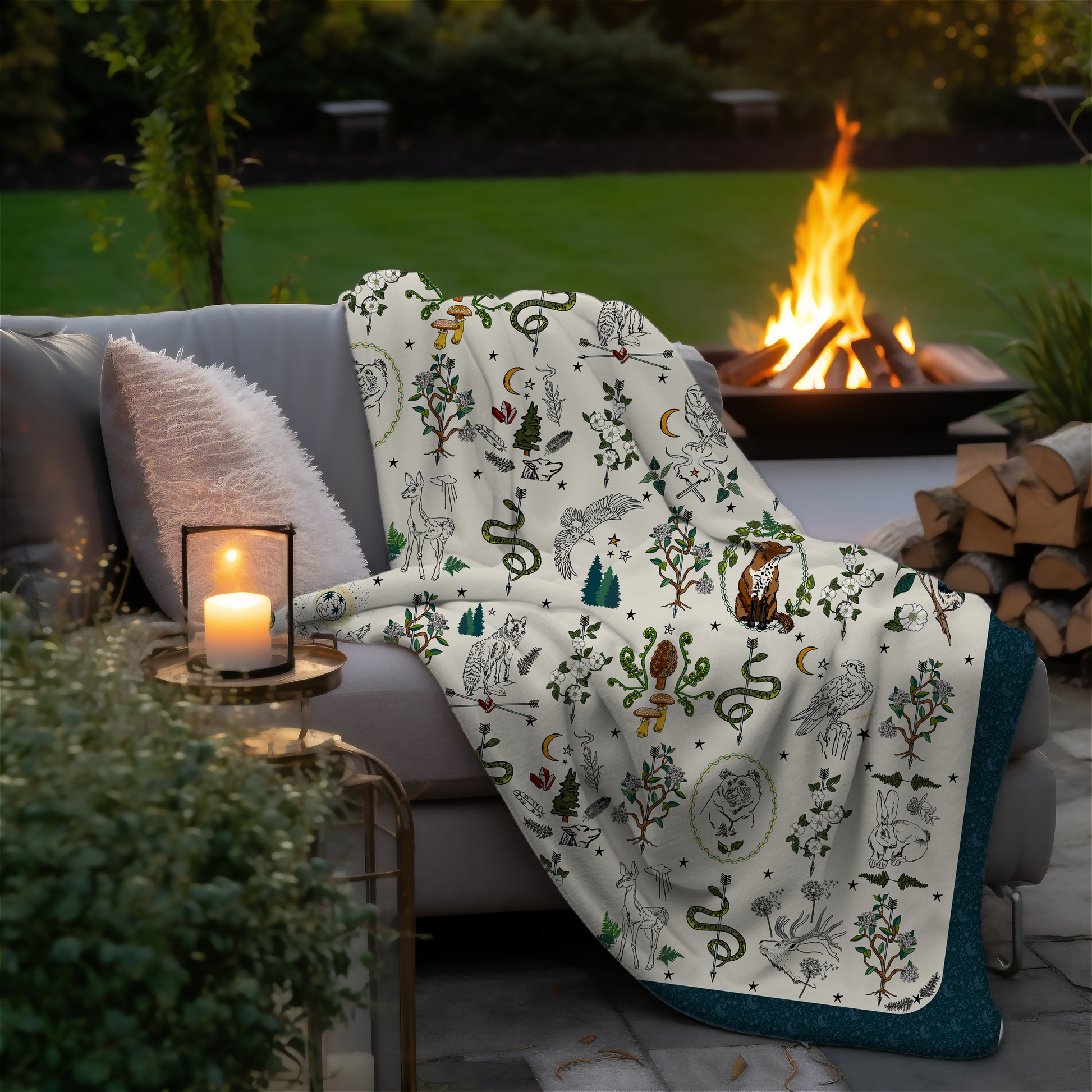 Fierce, Feral, and Free sherpa blanket draped over a couch by a fire pit in an outdoor setting.