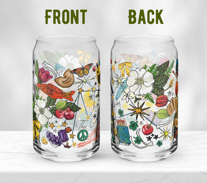 Two glasses sitting on marble. Each one is turned in a different direction to show the front and the back of the design. In addition to the Aquarius Constellation artwork, the illustration includes a golden finch with a crown, cherries, crescent moons, matches, bows, fortune cookies, wild roses, a fortune-telling fish, butterflies, crystals, a peace sign, and other symbols of good fortune. 