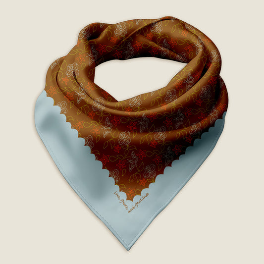 The Cowgirl Stitches bandana on an ivory background.