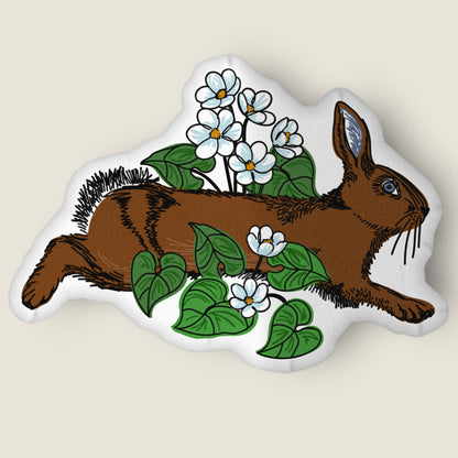 Rabbit and flower-shaped pillow on an ivory background.