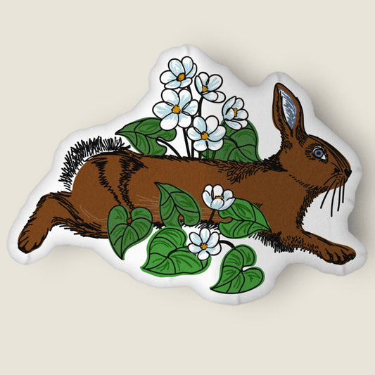 Rabbit and flower-shaped pillow on an ivory background.