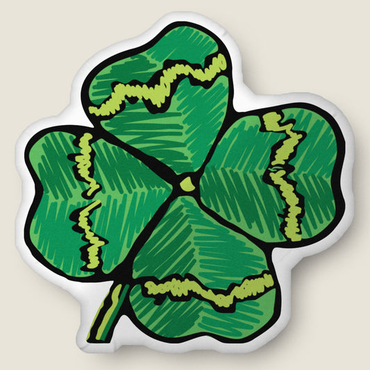 Four leaf clover-shaped pillow on an ivory background.