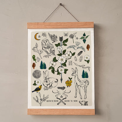 Born to Roam art print poster hung in a wood wall hanger. The artwork has drawings of wild roses, an owl, deer, rabbit, wolf, a crescent moon, ferns, crystals, mushrooms, dandelions, burning matches, and forest icons.