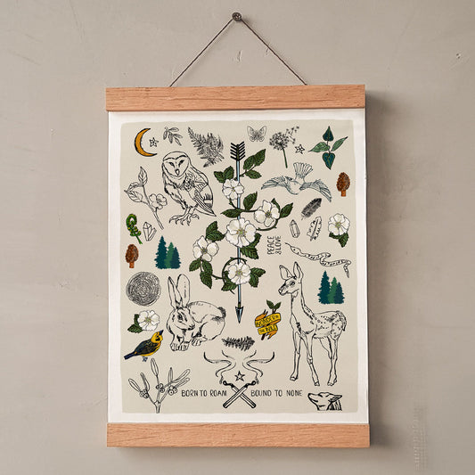 Born to Roam art print poster hung in a wood wall hanger. The artwork has drawings of wild roses, an owl, deer, rabbit, wolf, a crescent moon, ferns, crystals, mushrooms, dandelions, burning matches, and forest icons.