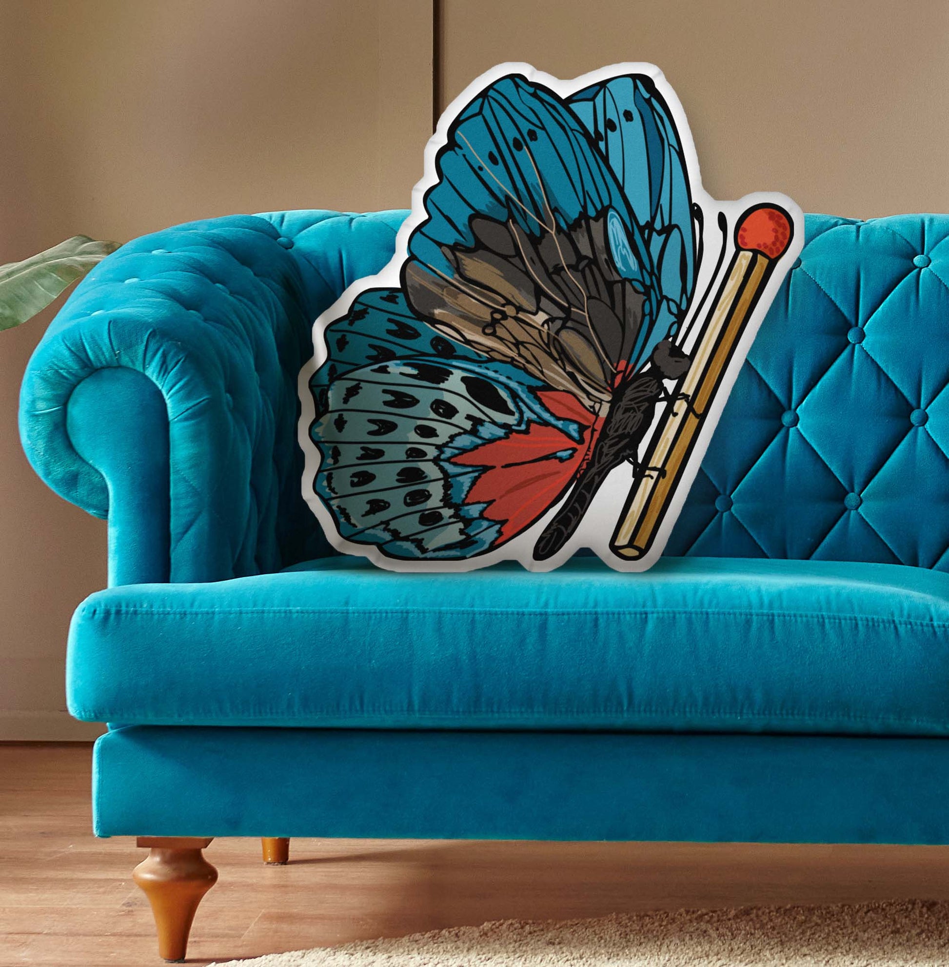 This photo shows the pillow on a bright blue couch.
