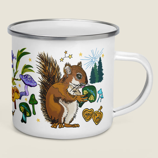 The Cygnus Constellation camp mug on an ivory background. The artwork shows illustrations inspired by the cosmic good fortune of the forest. There's a gold locket with the words "you + me", magical mushrooms, pine trees, stars, and a cheeky squirrel.