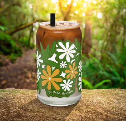 This is a photo of the glass containing an iced latte. It's sitting on a rock in the woods.