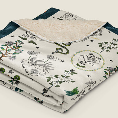 Fierce, Feral, and Free Faux Fur Sherpa blanket folded and laying on an ivory background.